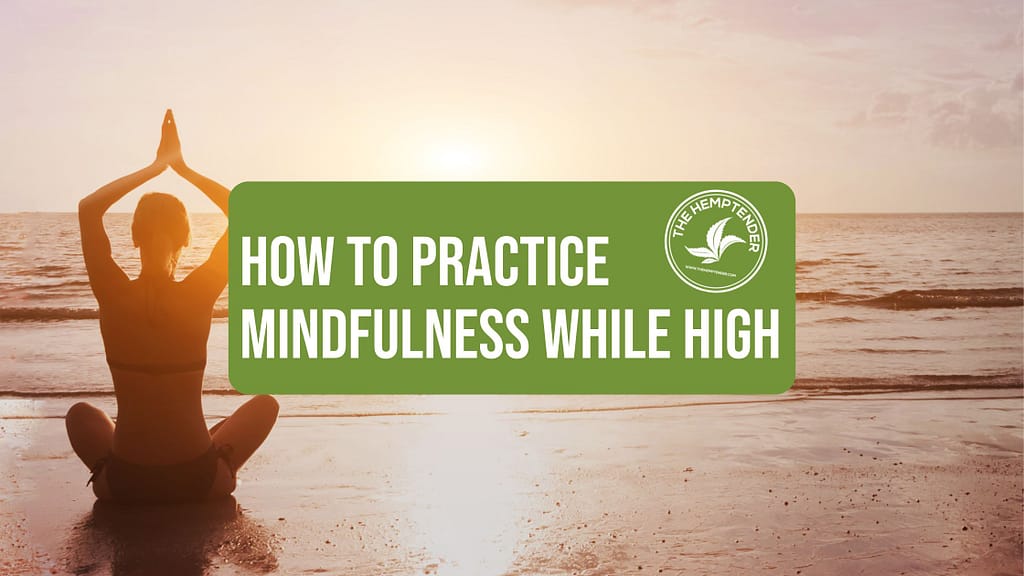A serene image of a person sitting cross-legged on the beach, facing the ocean at sunset, with their hands raised in a meditation pose. The text "How to Practice Mindfulness While High" is prominently displayed in a green box, along with the logo of The Hemp Tender, featuring a cannabis leaf. The overall tone of the image is peaceful and reflective, suggesting a connection between mindfulness, nature, and the use of cannabis.